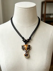 Close-up of resin elephant head pendant with vintage bone texture and braided rope