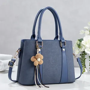 Minimalist fog blue tote bag with patchwork fabric design and flower charm accessory