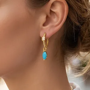 18K gold plated drop earrings with blue marquise stone and zircon on a model