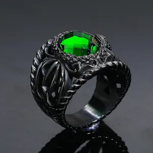 Macro detail of gothic style black titanium ring with a large emerald green gemstone