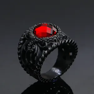Macro shot of red gemstone set in black engraved stainless steel ring for men