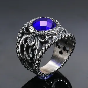 Detailed macro view of vintage titanium steel ring with hollow carving and blue gemstone
