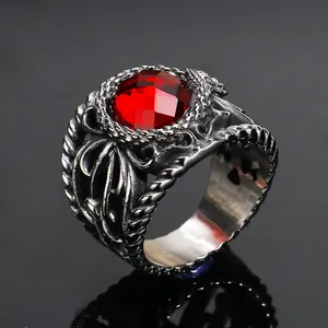 Macro shot of retro gothic steel ring with red gemstone and skull relief details