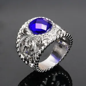 Retro stainless steel ring for men featuring an oval deep blue gemstone and carved textures
