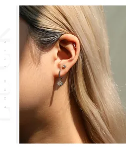 Detailed close-up showing stylish sterling silver moissanite earrings on a model's ear