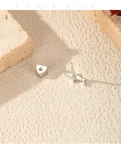 Detailed macro view of S925 silver screw-back stud showing heart shape and animal motif