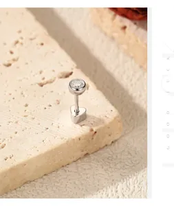 Macro view of D color moissanite ear stud with sterling silver heart base