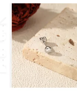 Detailed macro shot of a S925 silver stud earring featuring moissanite and heart threaded back