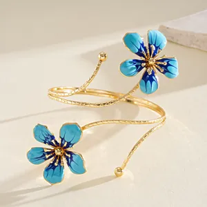 Close-up of vintage gold armlet with intricate blue enamel flower details