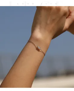 Close-up of marquise-cut moissanite bracelet on wrist in silver