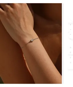 Close-up detail of a minimalist 925 sterling silver bracelet with a sparkling moissanite stone.