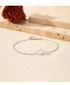 Detailed close-up of a pear-cut moissanite sterling silver bracelet on a stone surface