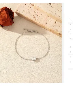 Close-up view of a sparkly moissanite gemstone set on a fine silver chain bracelet.