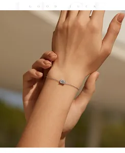 Close-up of minimalist S925 sterling silver bracelet with emerald-cut moissanite