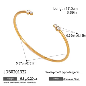 Gold stainless steel cuff bracelet with crystal ends showing size and weight specs
