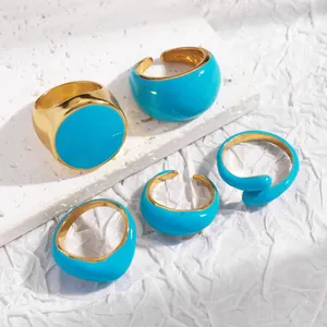 Set of five gold-plated rings with vibrant blue enamel glaze in geometric designs