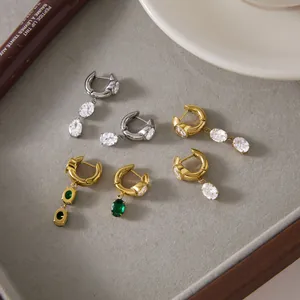 Detailed view of 18k gold-plated titanium steel earrings with sparkling crystal pendants.