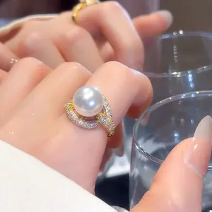 Close-up view of 18k gold plated ring with large white pearl and sparkling zircons