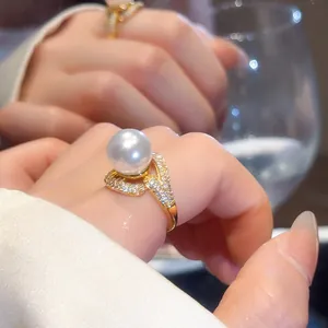 Close-up of a luxury 18k gold plated ring featuring a large white pearl and pavé zircons
