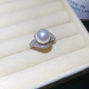 Elegant close-up of a luxury 18k gold plated pearl ring with shimmering zircon details