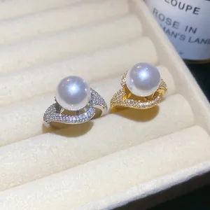 Close-up of luxury 18k gold plated zircon pearl rings in a velvet box