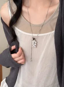Elegant grape cluster pearl necklace with natural stone detail shown on a model