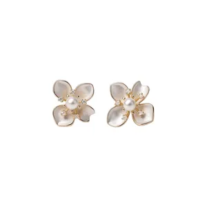 Elegant camellia flower stud earrings with central pearl and sparkling crystal accents