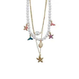 Layered pearl necklace with colorful starfish and fish tail charms for summer vacations.