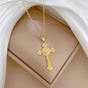 Elegant gold cross necklace with zircon inlays on luxury satin background