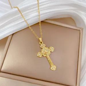 Close-up of golden cross pendant with radiant texture on luxury silk background