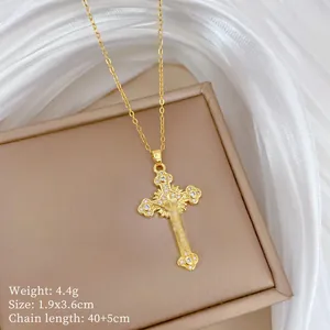 Detail view of gold cross pendant with cubic zirconia, weight 4.4g, size 1.9x3.6cm