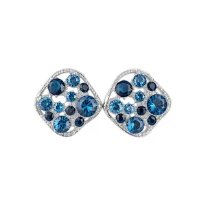 Elegant silver stud earrings with sparkling blue zircons in an irregular hollow design.