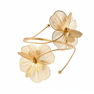 Elegant gold metal arm cuff jewelry featuring intricate filigree flower petal designs for women