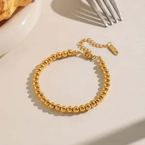 Close-up of a 18K gold-plated stainless steel bead bracelet with adjustable lobster clasp