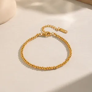 Close-up of golden beaded stainless steel bracelet with lobster clasp and extender