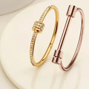 Titanium steel nail bracelet with diamonds and cylindrical open bangle set in gold tones