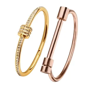 Polished titanium steel bracelets with diamond inlay and sleek geometric bangle designs