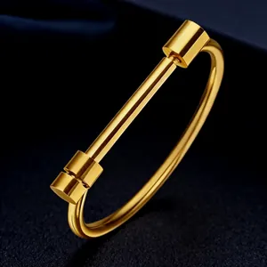 Close-up of a polished gold titanium steel bolt bracelet on a dark textured background