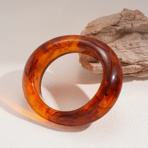 Premium amber resin bangle featuring dark brown marble swirl pattern and glossy finish