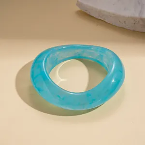 Blue marble resin bangle with irregular geometric design for a modern minimalist look