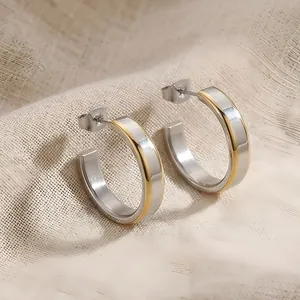 Detailed view of two-tone C-shape stainless steel earrings with gold and silver finish