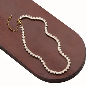 Gold plated heart zirconia necklace set with multi-row claw setting on wooden display