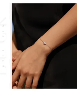 Close-up of a delicate S925 sterling silver bracelet with a 1ct moissanite on a wrist.