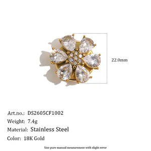 Detail of 18K gold-plated stainless steel flower cufflink with clear teardrop crystals.