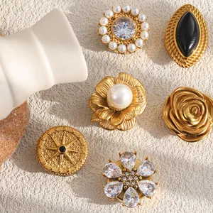 Detailed view of vintage 18K gold plated cufflinks with pearl and floral designs.