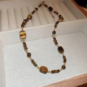 Elegant handmade beaded necklace with tiger's eye style glass beads in a luxury display box.