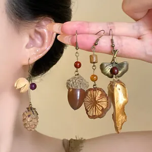 Vintage ethnic style earrings featuring realistic pine cone and acorn pendants.