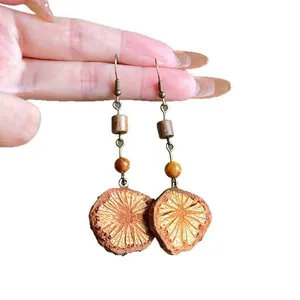 Vintage ethnic drop earrings with natural wood slices and bronze hook details