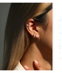 Vue détaillée en gros plan de clous d'oreilles en argent Moissanite S925 sur modèle.