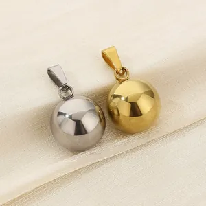 Detailed view of gold and silver mirror polished solid stainless steel ball pendants